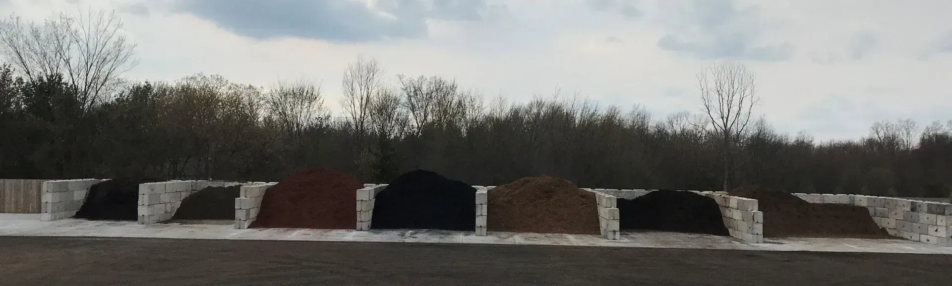 Bulk topsoil and mulch bins at the KBK Garden Center yard, ready for Dexter deliveries
